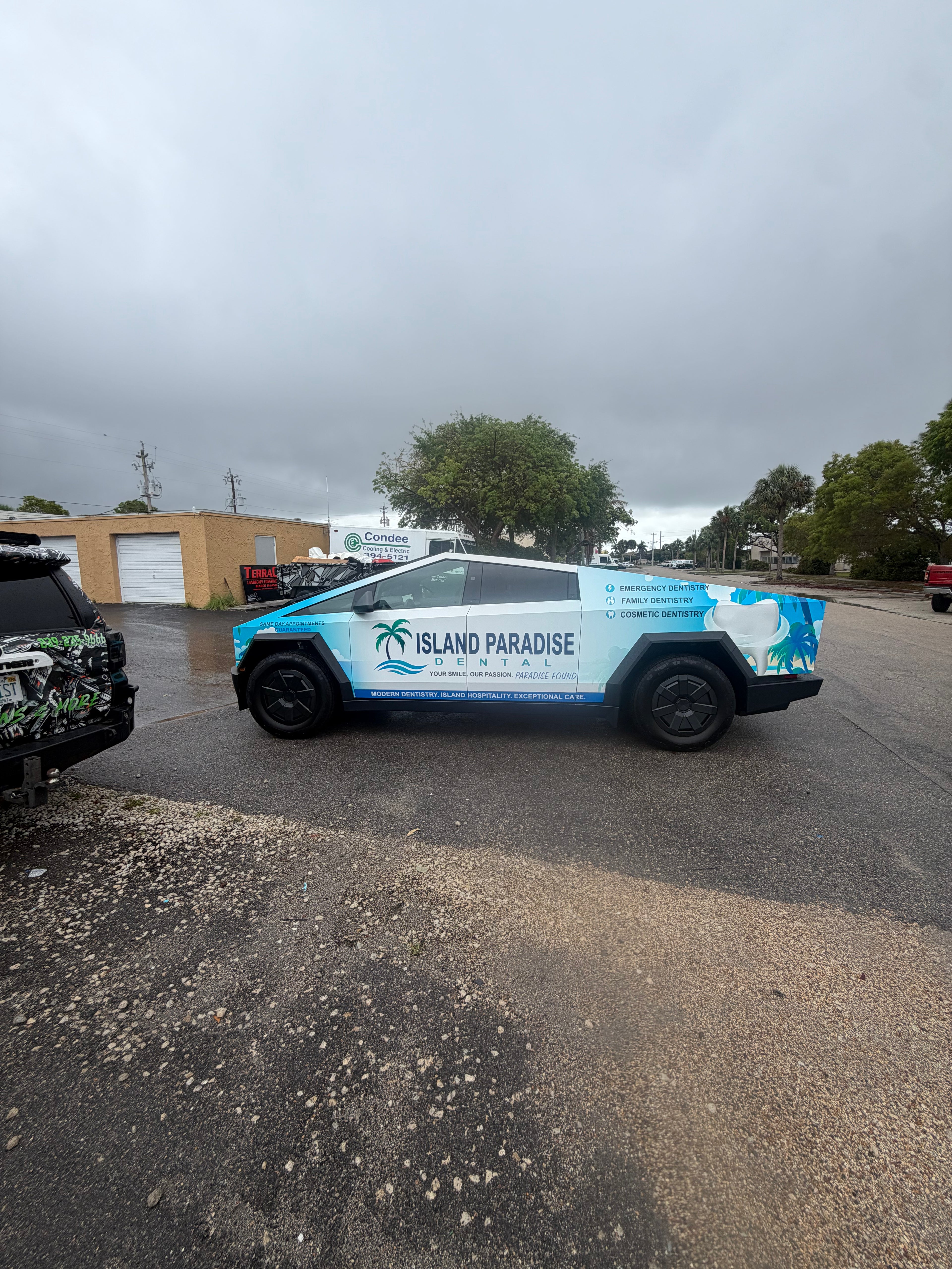 Van with 'Island Paradise' branding on a street